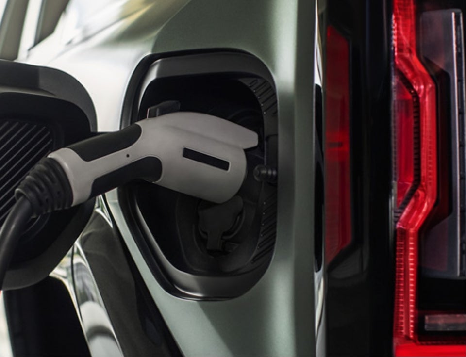 Close up of charging port with charger plugged in on a GMC Hummer EV SUV - Nick Mayer GMC in LEWISBURG TN